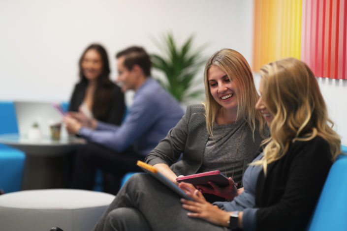 team collaborating on couch at bright age social media agency