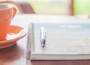 social media blog writing pen on notebook with coffee cup