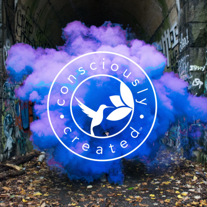 consciously created logo consciously created logo displayed on colorful smoke cloud