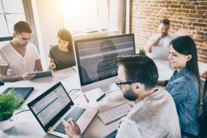 Social media experts at work to show the Advantages of Using a Social Media Agency vs. Creating an In-House Team