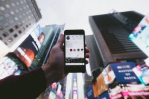 Cell phone with Instagram in city
