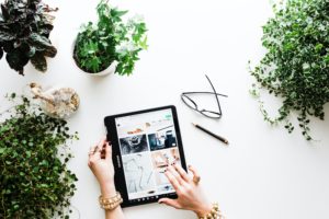 Social media marketing agency photo of plants, glasses, desk and ipad for blog post