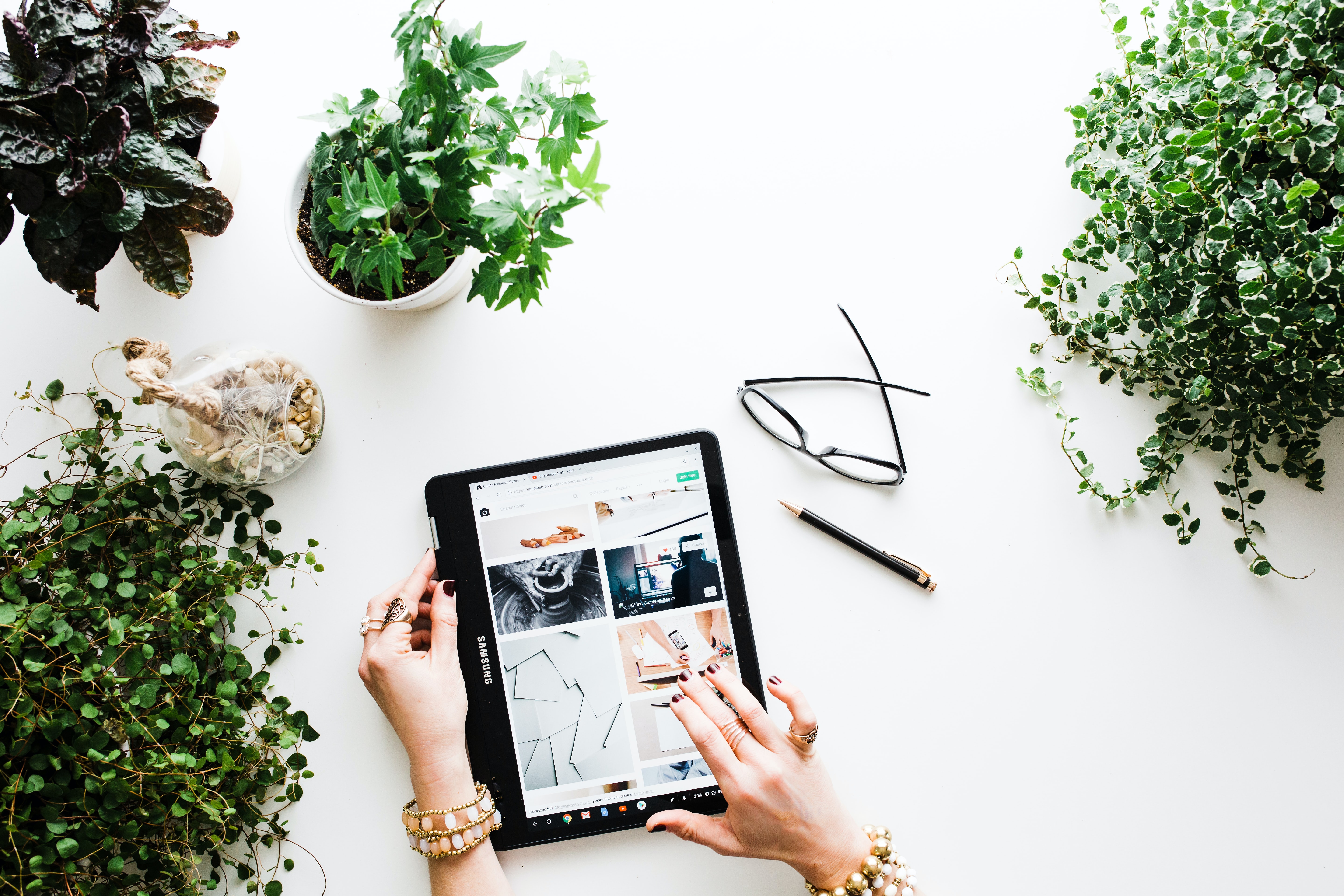 Social media marketing agency photo of plants, glasses, desk and ipad for blog post