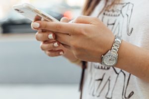 Picture of girl on phone to show importance of mobile optimization with a content marketing agency