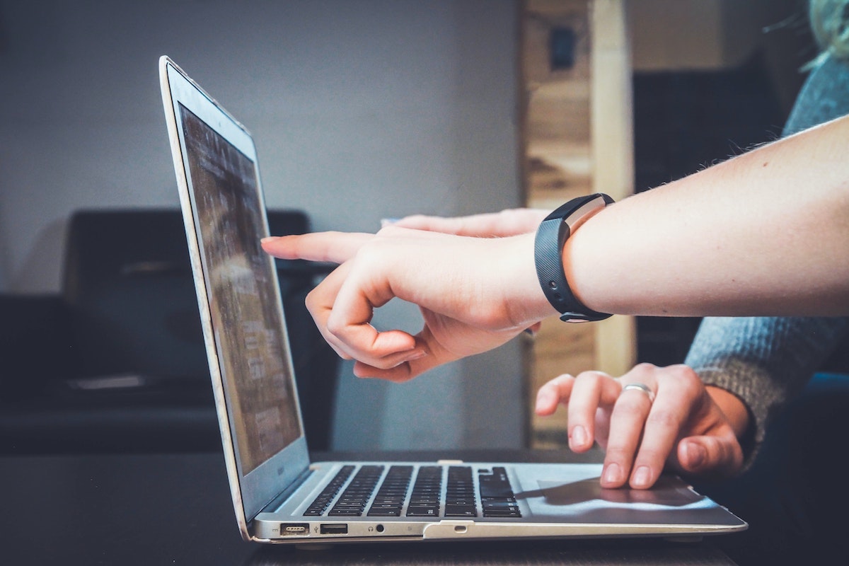 Image of people working on laptop to visualize a social media advertising agency