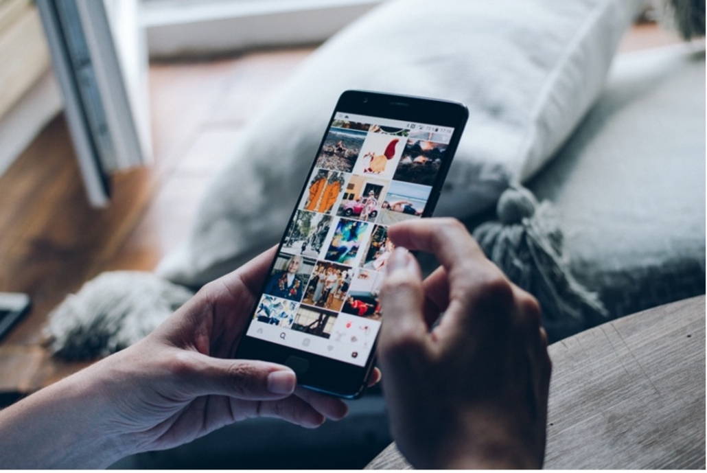 social media content agency using iphone to view instagram