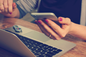 Using phone and laptop for social media company