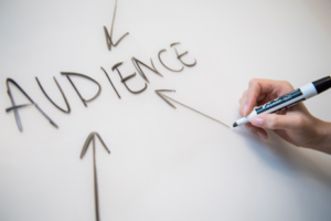 Writing audience on a whiteboard at social media company