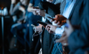 Crowd of people on their phones doing social media shopping