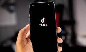 Man going on TikTok on phone to do social media shopping