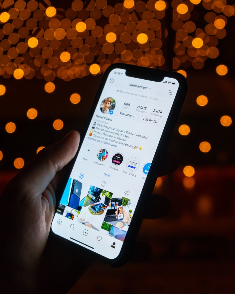 Phone in Hand Looks at Social Profile for Instagram Marketing Agency