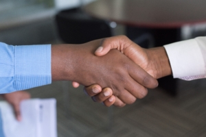 Associates shaking hands in agreement and approval